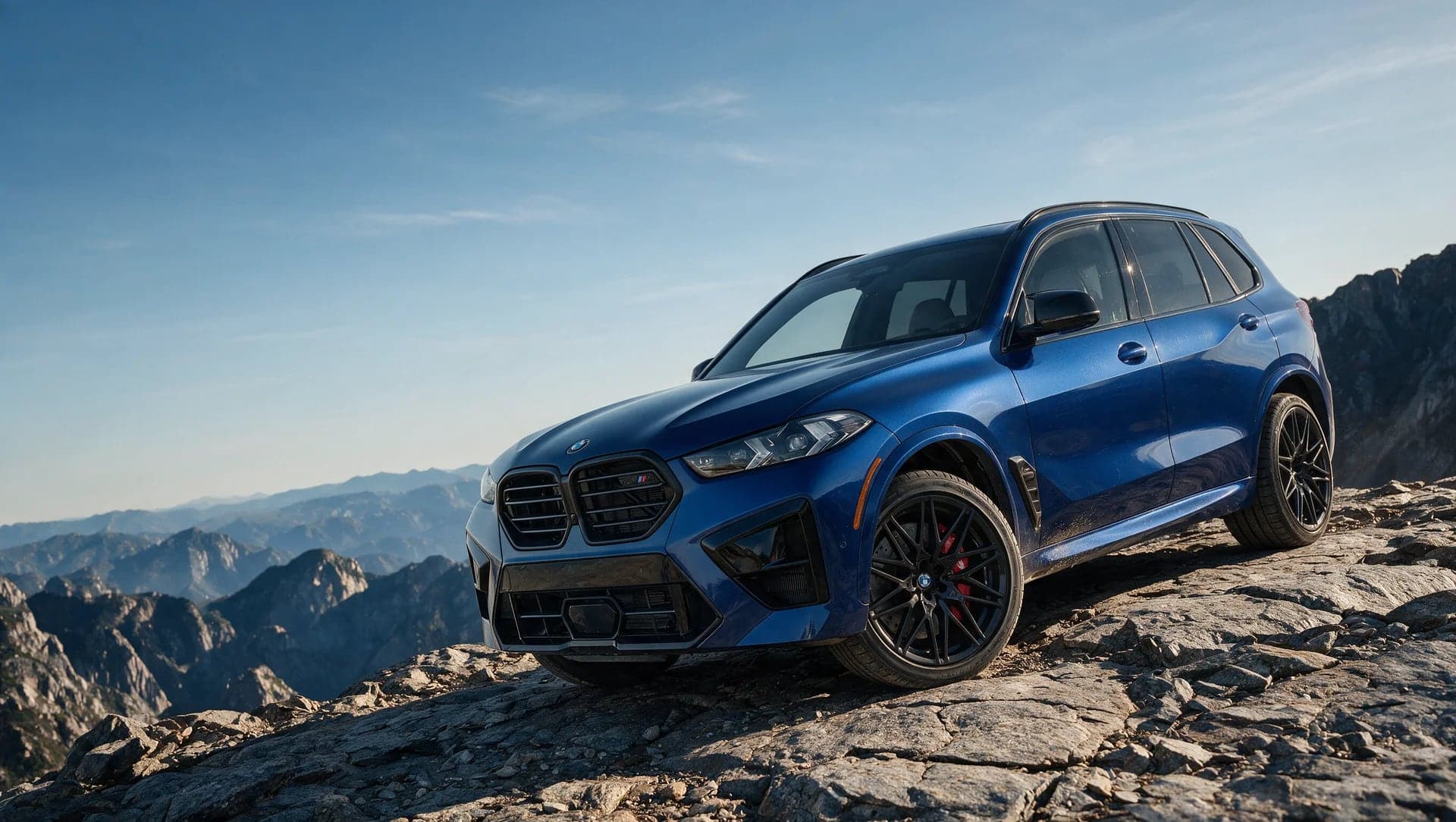 A blue BMW X5 M Competition parked on a rocky mountain ridge