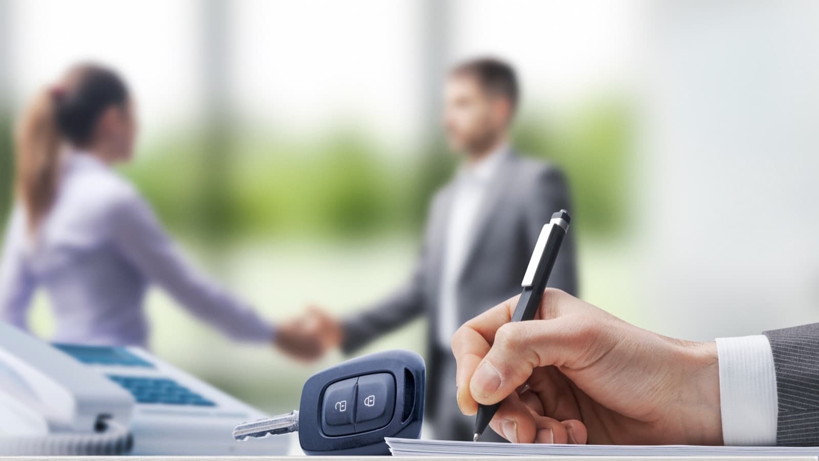 A customer and a broker shaking hands on a deal