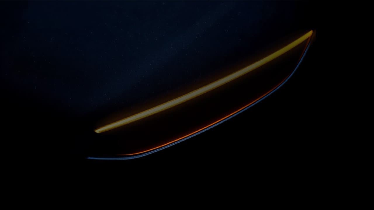 A sharp amber highlight along the edge of a dark car body