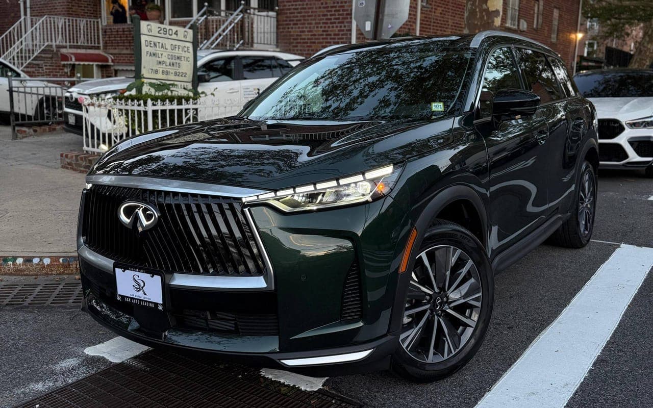 A dark green Infiniti QX60 parked on a city street, seen from the front